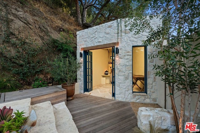 wooden terrace featuring an outdoor structure