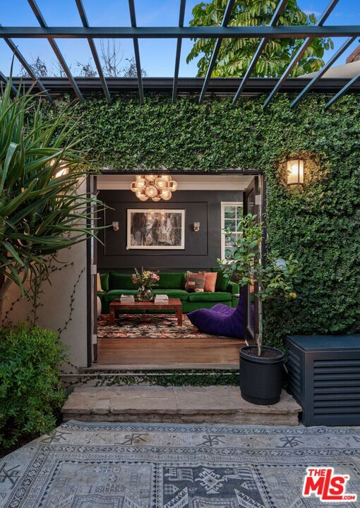 entrance to property featuring a pergola