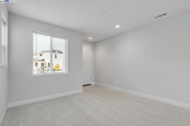 unfurnished room with light colored carpet