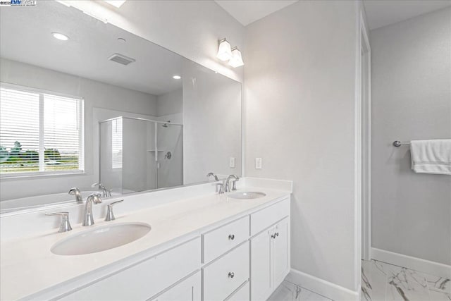 bathroom featuring vanity and a shower with shower door