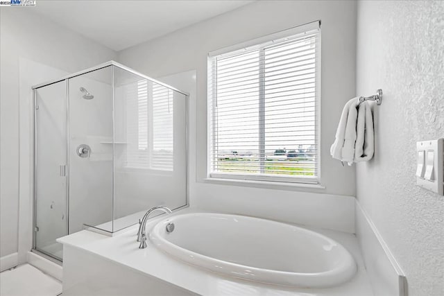 bathroom featuring plus walk in shower