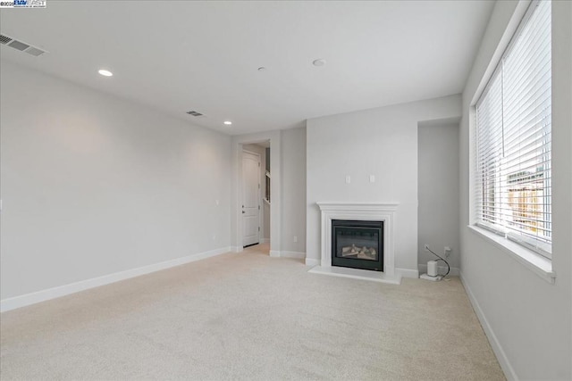 unfurnished living room with light carpet