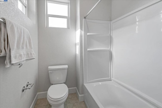 bathroom with toilet, shower / bath combination, and tile patterned flooring