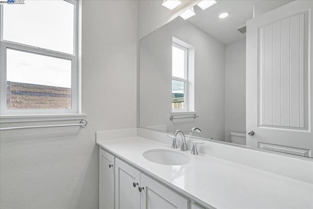 bathroom featuring vanity and toilet