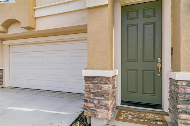 entrance to property featuring a garage