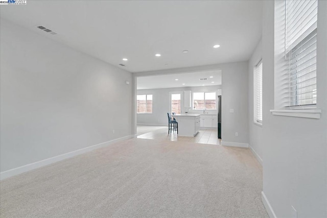 unfurnished living room with light carpet