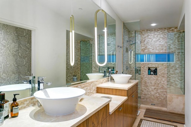 bathroom featuring vanity and tiled shower