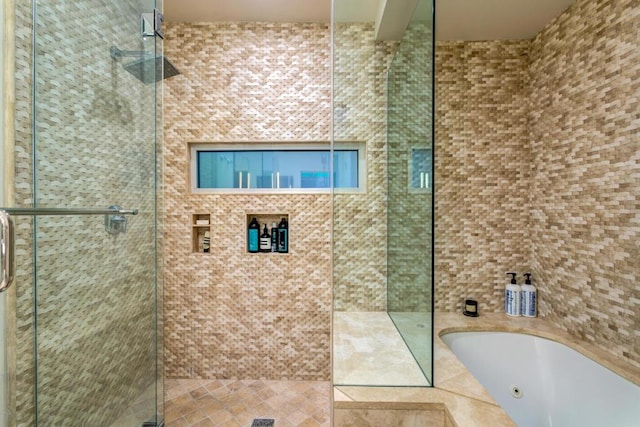 bathroom featuring independent shower and bath