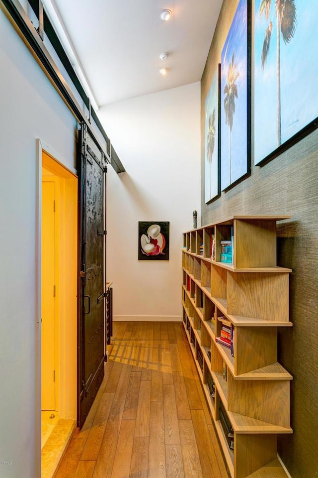 hallway featuring light hardwood / wood-style flooring and a barn door