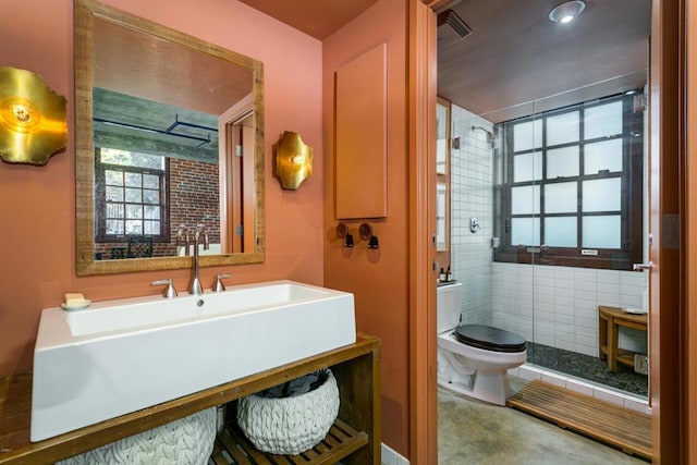 bathroom with sink, plenty of natural light, and toilet