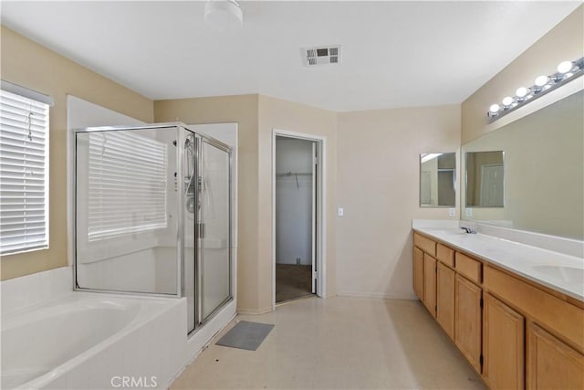 bathroom featuring vanity and separate shower and tub