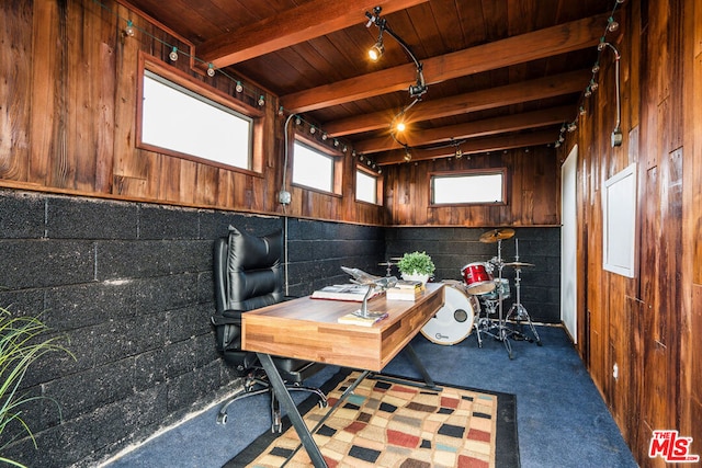 carpeted office space with track lighting, wooden walls, beam ceiling, and wooden ceiling