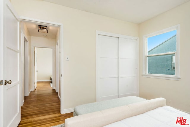 bedroom with hardwood / wood-style flooring and a closet