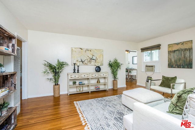 living room featuring hardwood / wood-style floors and ceiling fan