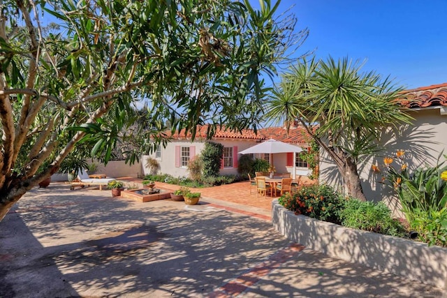 mediterranean / spanish house with a patio area