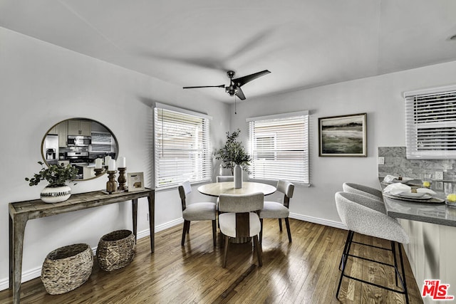 dining space with dark hardwood / wood-style floors and ceiling fan