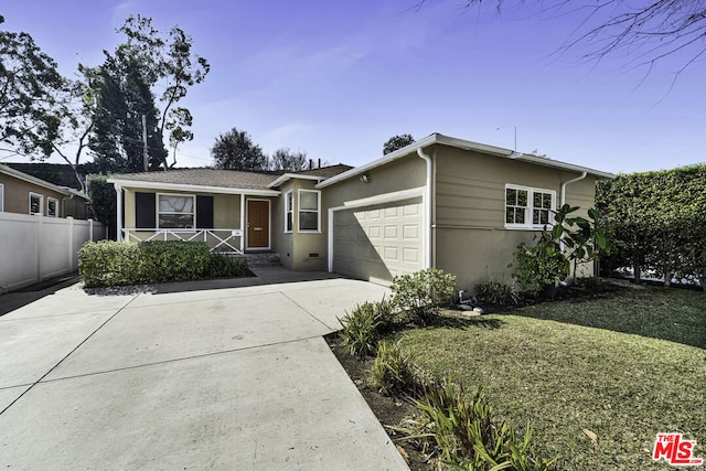 ranch-style home with a garage and a front lawn