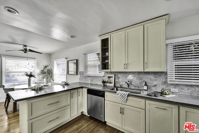 kitchen with stainless steel dishwasher, cream cabinets, kitchen peninsula, and sink