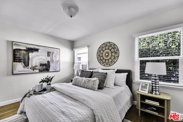 bedroom with dark wood-type flooring