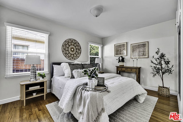 bedroom with dark hardwood / wood-style flooring