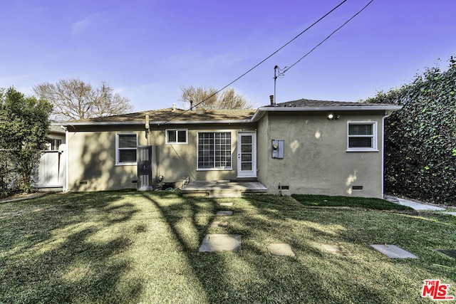 rear view of house with a yard and a patio area