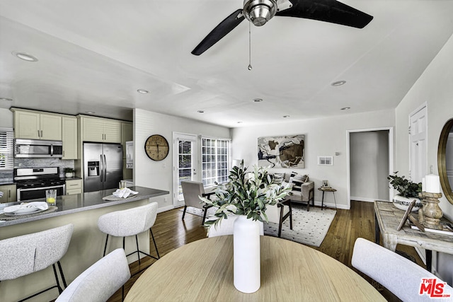 dining room with dark wood-type flooring and ceiling fan