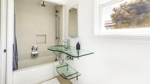 bathroom with sink and shower / tub combo with curtain