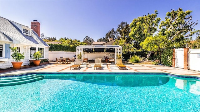 view of swimming pool featuring a gazebo and a patio