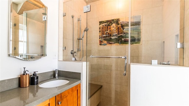 bathroom with vanity and a shower with door