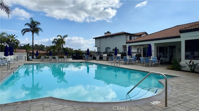 view of swimming pool with a patio