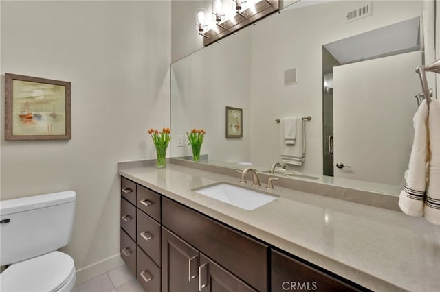 bathroom featuring vanity, toilet, and tile patterned flooring