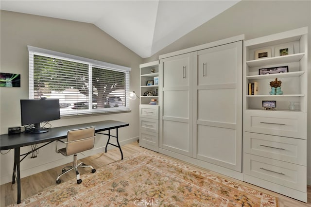 office featuring lofted ceiling and light wood-type flooring