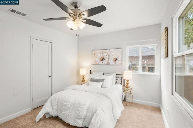 bedroom with light colored carpet and ceiling fan