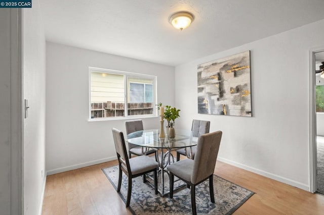 dining space with light hardwood / wood-style flooring