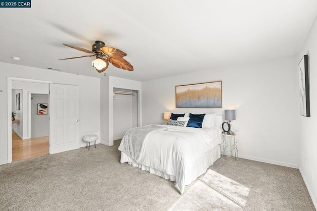 carpeted bedroom with a closet and ceiling fan