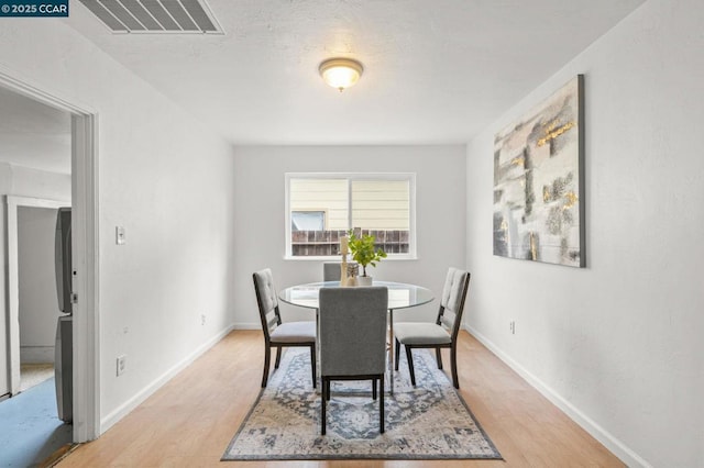 dining area with light hardwood / wood-style flooring