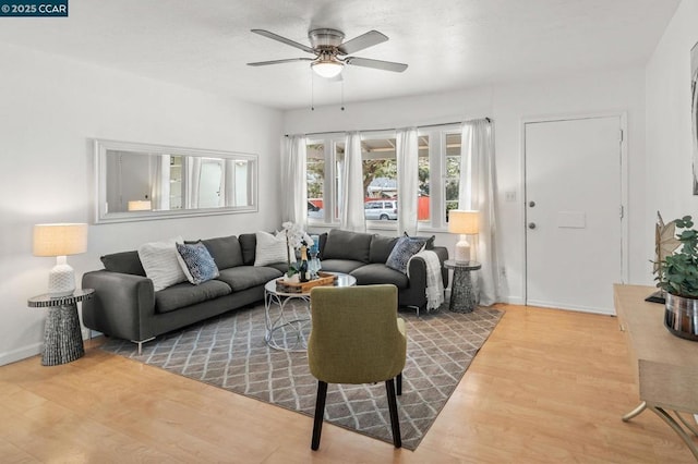 living room with hardwood / wood-style flooring and ceiling fan