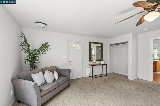 living room with light colored carpet and ceiling fan