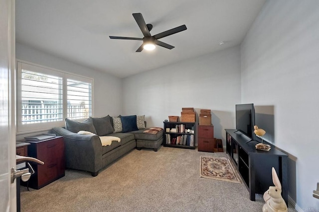 living room featuring ceiling fan, light colored carpet, and vaulted ceiling