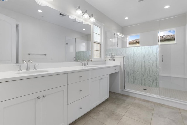 bathroom with vanity, an enclosed shower, and tile patterned flooring