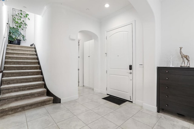 tiled foyer with crown molding