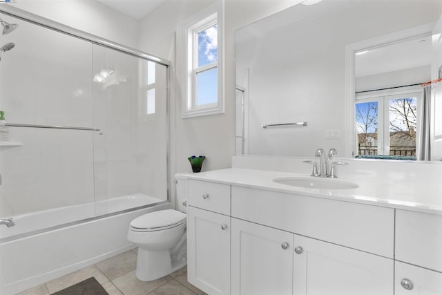 full bathroom with toilet, plenty of natural light, shower / bath combination with glass door, and tile patterned flooring