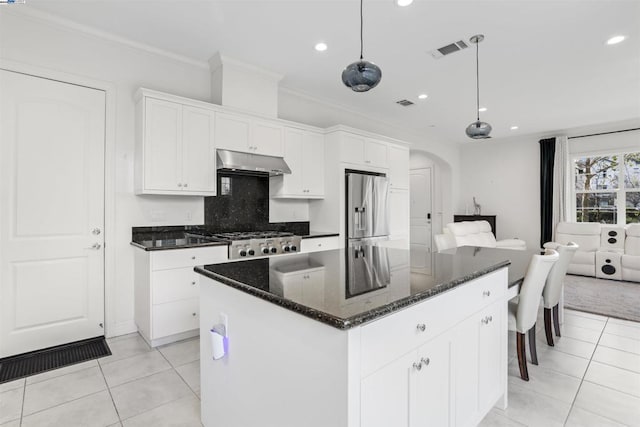 kitchen featuring stainless steel refrigerator with ice dispenser, hanging light fixtures, a kitchen island, and white cabinets