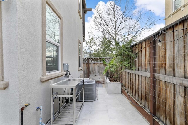 balcony featuring cooling unit and a patio