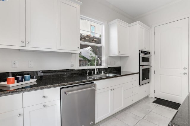 kitchen featuring stainless steel appliances, sink, and white cabinets