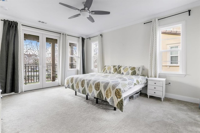 carpeted bedroom with multiple windows, access to outside, french doors, and ceiling fan