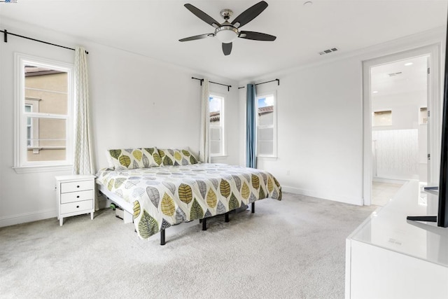 carpeted bedroom featuring ceiling fan and ensuite bathroom