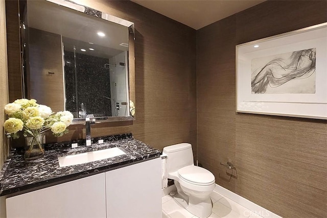 bathroom featuring vanity, tile patterned floors, and toilet