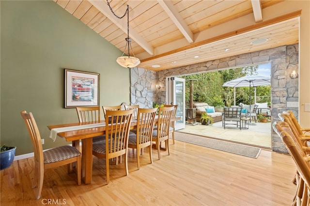 dining room with wooden ceiling, wood finished floors, and vaulted ceiling with beams