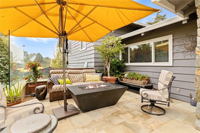 view of patio featuring an outdoor living space with a fire pit